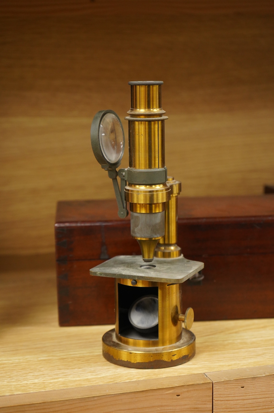 A mid 19th century French brass compound monocular microscope, by G. Oberhaeuser & E. Hartnack, Place Dauphine, Paris, number 2953, with an additional eyepiece, an objective and small box of slides, mahogany case 25.5cm